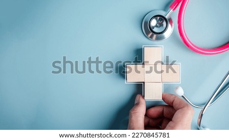 Health insurance concept. people hands putting plus symbol and healthcare medical wooden cube block with icon, health and access to welfare health concept	
