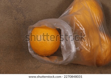 Pictured are oranges in a plastic bag.