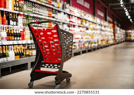 A shopping cart with grocery products in a supermarket