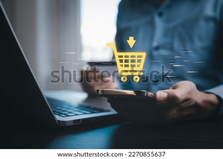 Businessman hold smartphone with online shopping concept, marketplace website with virtual interface of online Shopping cart part of the network, Online shopping business with selecting shopping cart. Royalty-Free Stock Photo #2270855637