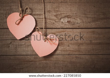 pink heart made of paper on wooden background