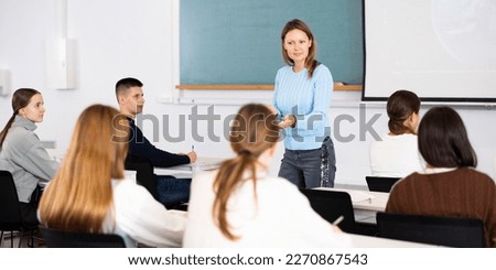 Female teacher teaching high school students in a school classroom Royalty-Free Stock Photo #2270867543