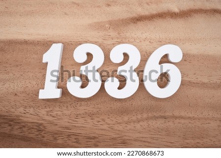 White number 1336 on a brown and light brown wooden background.