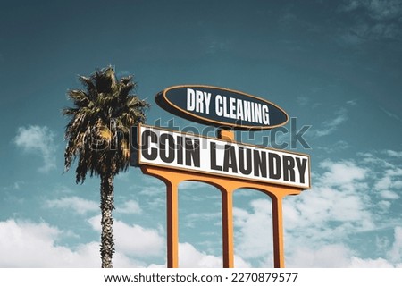 Vintage coin laundry and dry cleaning sign                               