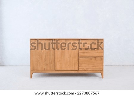 large bedside table with two doors and three drawers made of teak wood for home decoration Royalty-Free Stock Photo #2270887567