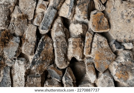 Texture of an old wall made of natural stones and red bricks. High quality photo
