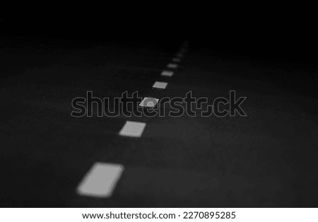 Dashed line above the road with dark background
