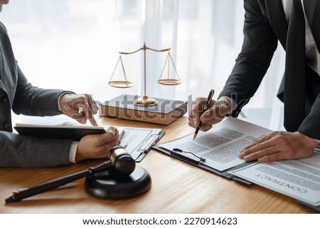 Lawyer, legal advisor, businessman brainstorming information on agreement details Business contracts in legal processing books for accuracy in contract documents. joint financial investment. Royalty-Free Stock Photo #2270914623