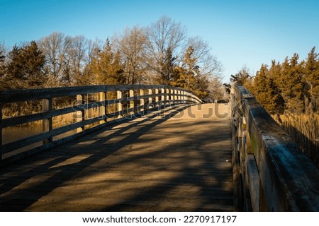 The wood bridge in Sunken Meadow State Park, New York, in the Winter  Royalty-Free Stock Photo #2270917197