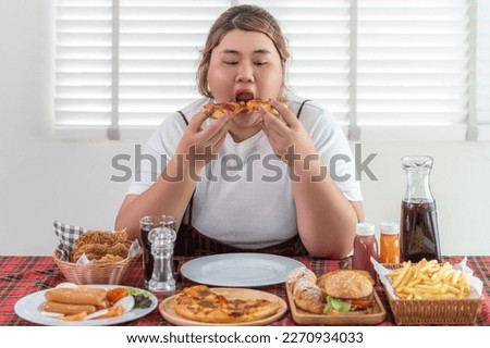 Asian over size fat woman enjoy over eating on the restaurant, un healthy foods and junk food concept photo