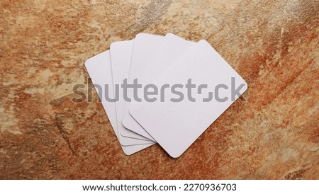 Playing cards modern mock up. Deck of playing card on a brown and beige marble surface.Blank white cards or business cards. Branding and holidays