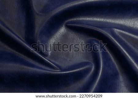 
blue artificial leather with waves and folds on PVC base