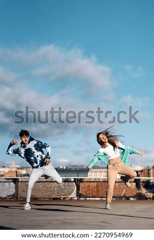 Stock photo of cool girl and her friend practicing their dance moves and having fun.