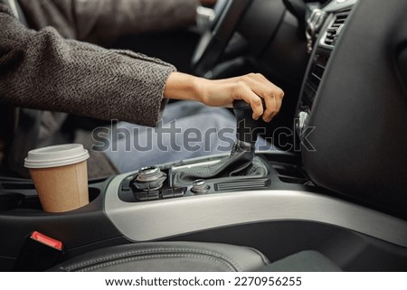 Close up of woman change speed holding hand on gearbox in the car Royalty-Free Stock Photo #2270956255