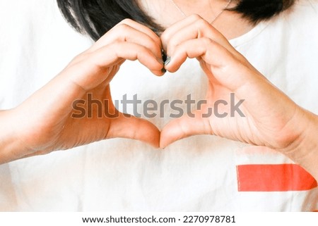 Woman making hand in heart shape, self love, self care. Mindfulness spiritual living lifestyle. Self worth, acceptance, actualisation. Royalty-Free Stock Photo #2270978781