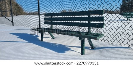 Wooden patio bench in the snow