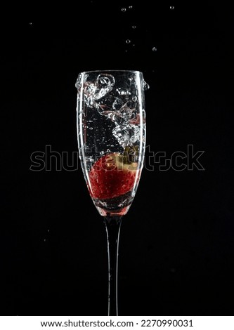 Champaign glass with strawberry black background