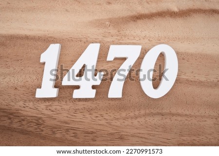 White number 1470 on a brown and light brown wooden background.