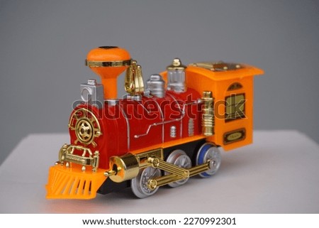 Toy train with one of its old-fashioned locomotives.