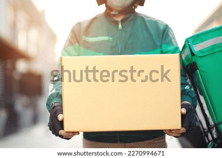 green rider parcel delivery man  of a package through a service send to home. hand holding consigns and submission customer accepting a of box. Royalty-Free Stock Photo #2270994671