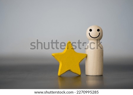 Wooden figures peg doll standing together with a yellow star. Talent, Human resources. Stand out from the crowd. Different and individual unique person. Spotlight shining to the best person Royalty-Free Stock Photo #2270995285