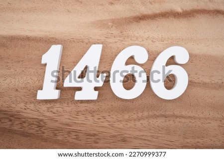 White number 1466 on a brown and light brown wooden background.