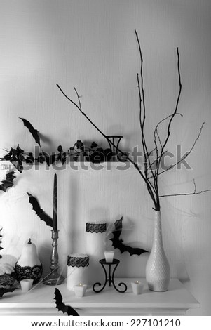 Halloween composition on fireplace in room