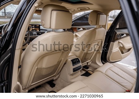 Open the passenger door rear left, right. Leather clean interior design, car driver seats, buttons, dashboard, nappa leather, beige. Interior of new modern expensive car. Closeup. Back view inside. Royalty-Free Stock Photo #2271030965