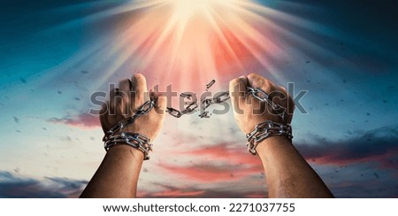Hands in fists breaking a chain freedom. The concept of gaining freedom. Royalty-Free Stock Photo #2271037755