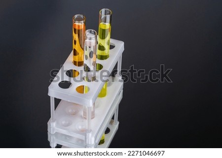 Close up solve and transparent lab test tubes. Isolated on black background.