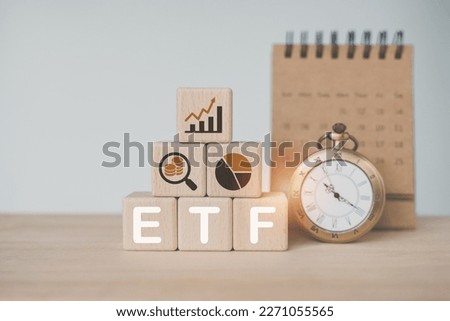 wooden cube with bitcoin icon standing with ETF text , Exchange Traded Fund, with blurred vintage and calendar. for business finance conceptual