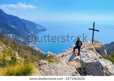 Woman hiker watching beautiful costal scenery - Path of the Gods "Sentiero degli Dei" the famous costal  hiking trail, Amalfi Coast, Italy Royalty-Free Stock Photo #2271062633