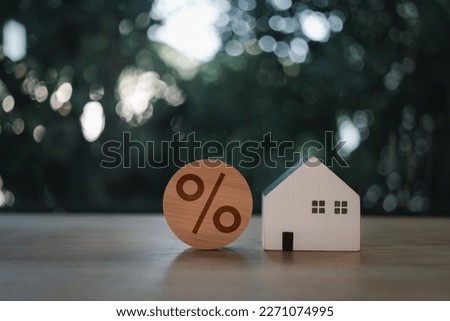 House is placed together with a percent icon on the wood block. The concept of rates interest increases. Interest rate financial and mortgage rates concept. Royalty-Free Stock Photo #2271074995