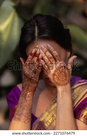 Bride. Beautiful young caucasian woman in traditional indian clothing with bridal makeup and jewelry. Gorgeous blonde bride. Mehndi, application of henna as skin decoration.