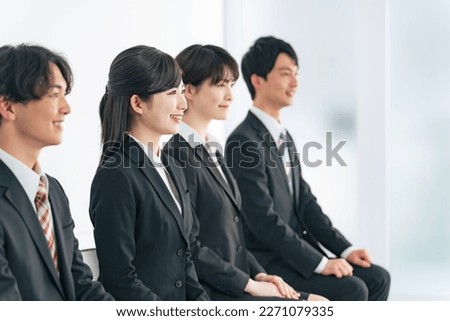 Group of young Asian men and women in suits. job hunting. Royalty-Free Stock Photo #2271079335