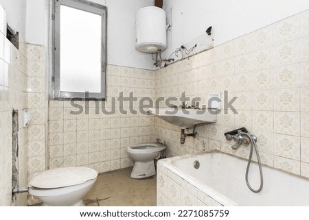 Dirty old bathroom in need of renovation, to renovate and modernize. Royalty-Free Stock Photo #2271085759