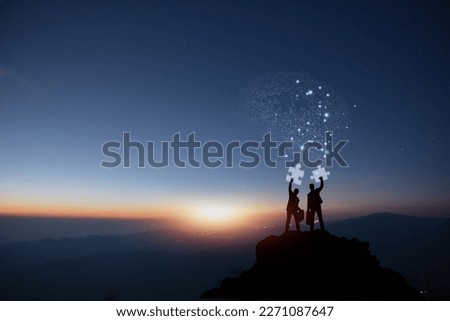 Two businessmen are holding pieces of a puzzle that will allow them to put all the information in their heads together and come up with an original idea in front of a moody background. Royalty-Free Stock Photo #2271087647