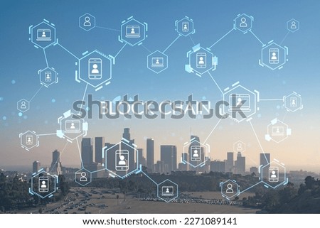 Skyline of Los Angeles downtown at summer sunset, California, USA. Skyscrapers of panoramic city center of LA. Decentralized economy. Blockchain and cryptography concept, hologram
