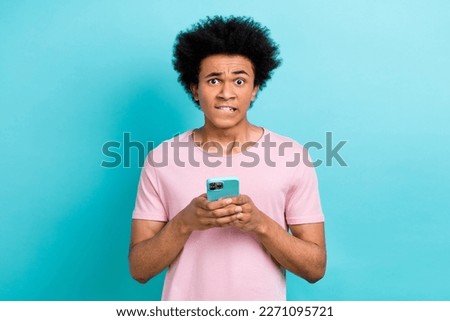 Photo of funny nervous blog owner young guy bite lips forgot password cannot login facebook account trouble isolate on aquamarine color background
