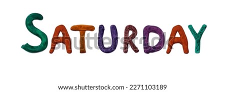 Saturday. Salt dough alphabet. Letters on a white background. Day of the week. Colored handmade letters.