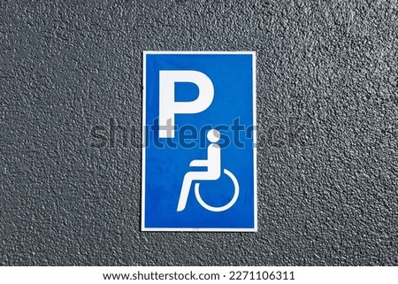 Disabled parking sign on the ground. Caring for people with health problems