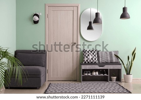 Interior of stylish hall with armchair and shoe stand Royalty-Free Stock Photo #2271111139