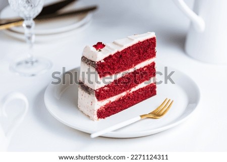Popular dessert called Red Velvet cake. It is served in many special occasions like International Woman's day or Valentine's day. Great layered cake with special cocoa and cream cheese between Royalty-Free Stock Photo #2271124311