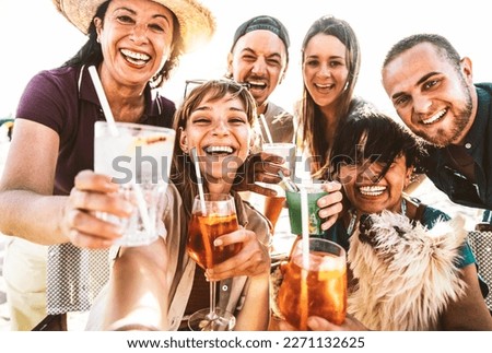 Happy family drinking cocktail glasses at bar restaurant terrace - Cheerful mixed age people taking selfie picture outside - Life style concept with guys and girls hanging out on summer vacation 