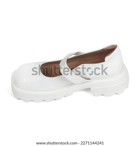 White leather women's shoes on a strap with a thick sole on a white background.