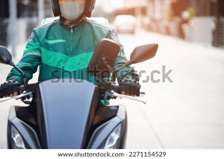 green rider Ready for fast food delivery with online applications Royalty-Free Stock Photo #2271154529