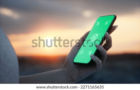 CU 20s Caucasian female holding a phone in a left hand, vertical orientation