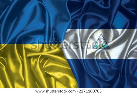 Ukraine and Nicaragua folded silk flag together