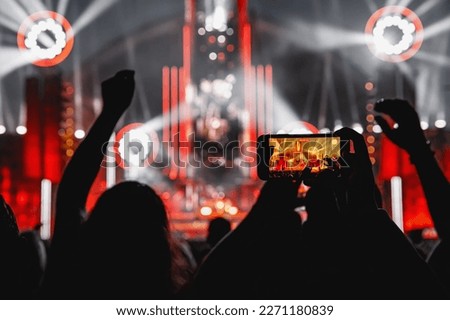 The crowd on a fan zone with the smartphone to record or take pictures during the live concert