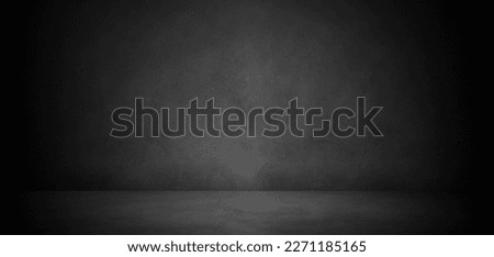 Wide dark concrete studio room background with low lighting for product display or mock up design. empty three dimensional concrete room backdrop.